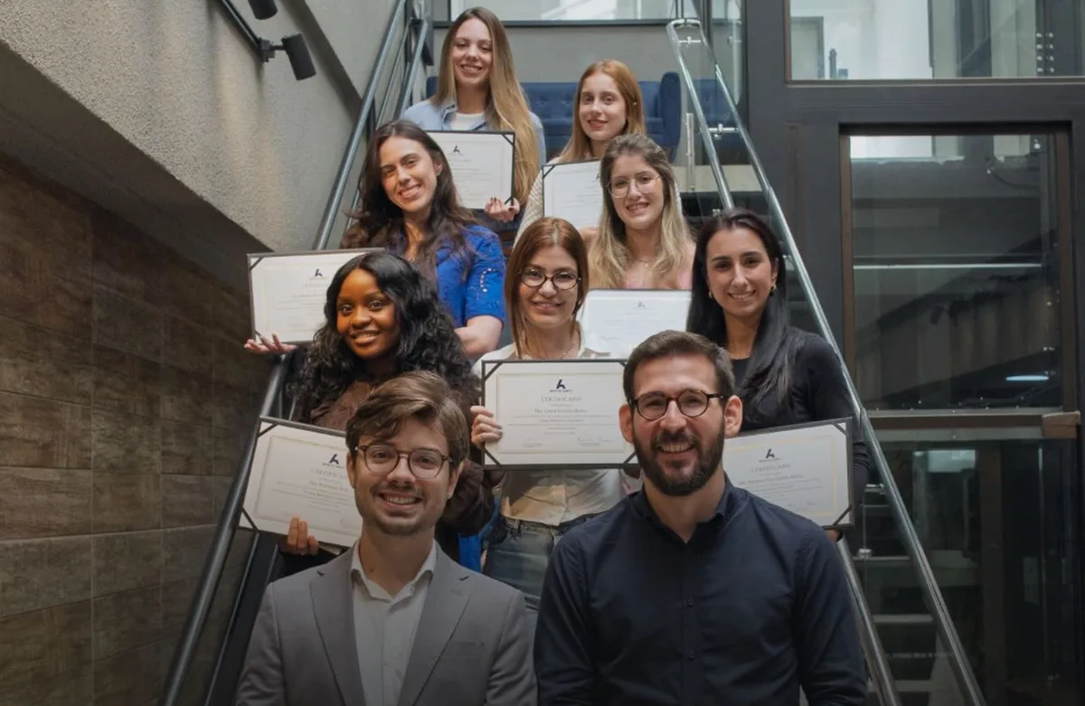 Turma do Toxina Unlocked na escada, com os certificados, e os dois coordenadores à frente